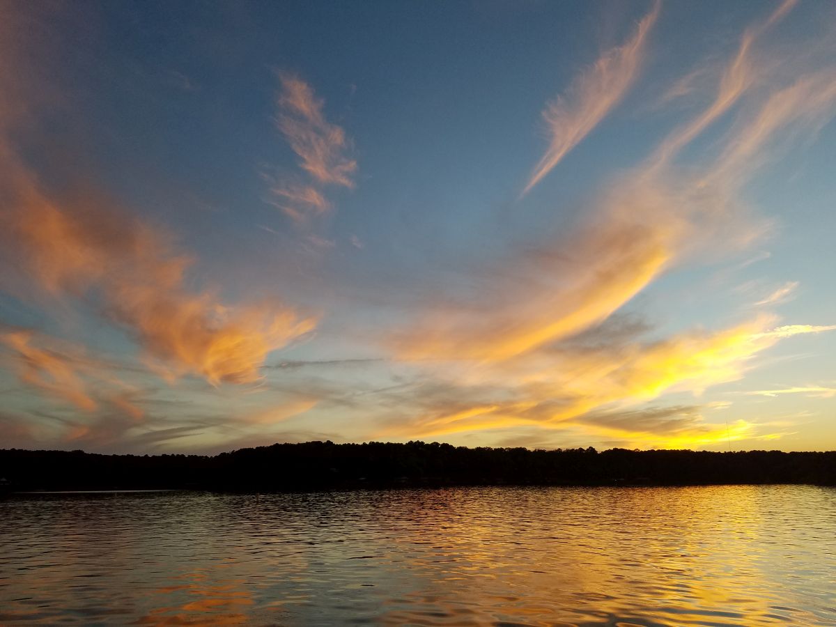 Sunset over Lake Cypress Springs and its wooded shoreline